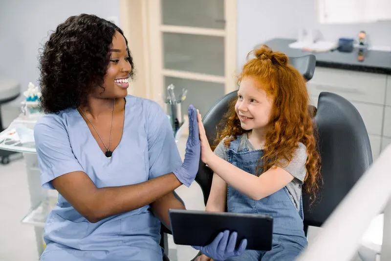 Child smiling during a gentle pediatric dental visit